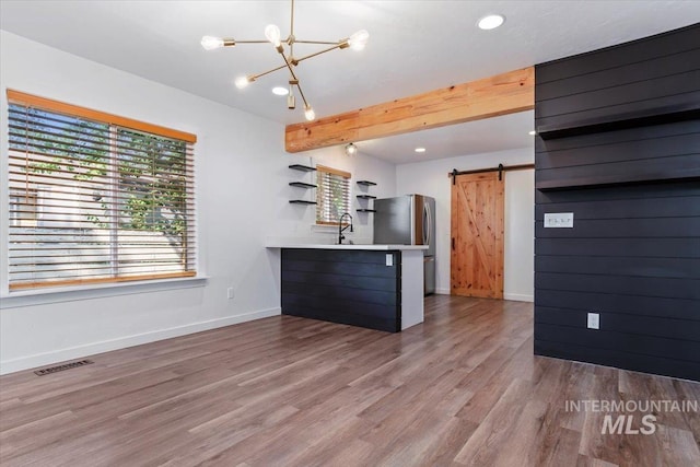 511 N 10th Ave N, Nampa, ID 83687 - kitchen featuring a barn door, open shelves, a chandelier, wood finished floors, and recessed lighting