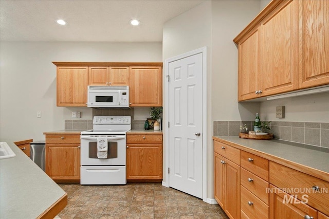 9425 W Java Ct, Boise, ID 83704 - kitchen with white appliances, decorative backsplash, light countertops, and recessed lighting
