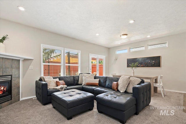 9425 W Java Ct, Boise, ID 83704 - living area featuring carpet flooring, recessed lighting, a tile fireplace, a textured ceiling, and baseboards