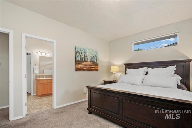 9425 W Java Ct, Boise, ID 83704 - bedroom with light colored carpet, baseboards, ensuite bath, and a sink