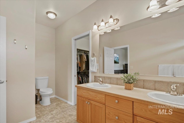 9425 W Java Ct, Boise, ID 83704 - full bath with double vanity, toilet, baseboards, and a spacious closet