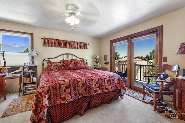 bedroom with access to outside, light carpet, ceiling fan, and a textured ceiling