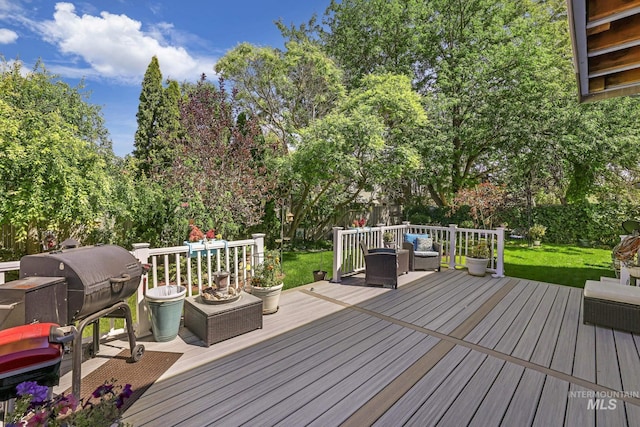 wooden deck featuring area for grilling, fence, and an outdoor living space