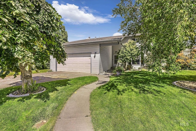 view of front of home with driveway, a front lawn, and an attached garage