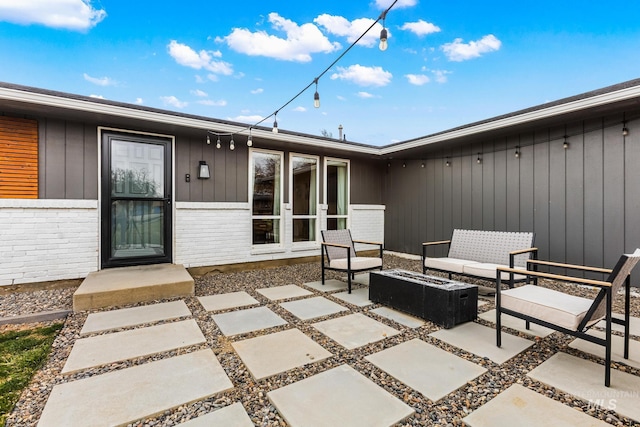 view of patio featuring an outdoor living space with a fire pit