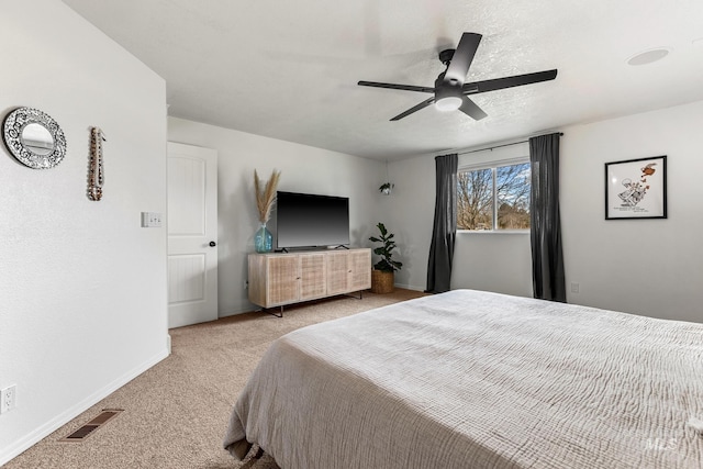 bedroom featuring visible vents, ceiling fan, baseboards, carpet, and a textured ceiling