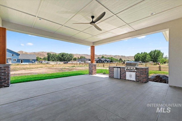 1360 Jordan Ln, Emmett, ID 83617 - view of patio / terrace featuring a mountain view, an outdoor kitchen, and a ceiling fan