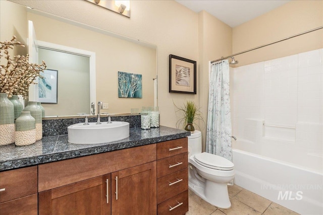 bathroom featuring toilet, tile patterned flooring, shower / bath combo with shower curtain, and vanity