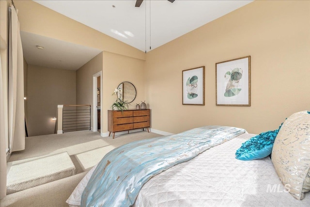 carpeted bedroom featuring lofted ceiling and ceiling fan