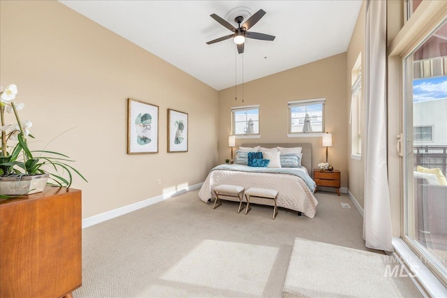 carpeted bedroom featuring baseboards, vaulted ceiling, and a ceiling fan