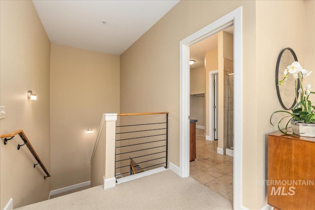 staircase with carpet floors and tile patterned flooring