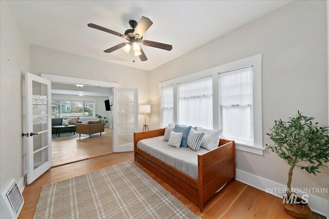 609 10th Ave S, Nampa, ID 83651 - interior space with visible vents, a ceiling fan, french doors, baseboards, and light wood-style flooring