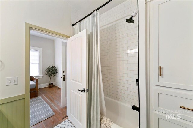609 10th Ave S, Nampa, ID 83651 - bathroom with shower / bath combo with shower curtain and wood finished floors