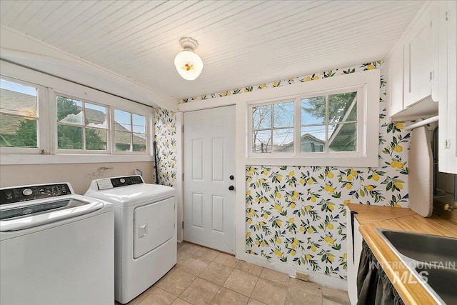 609 10th Ave S, Nampa, ID 83651 - laundry area with washing machine and dryer, wallpapered walls, plenty of natural light, and cabinet space