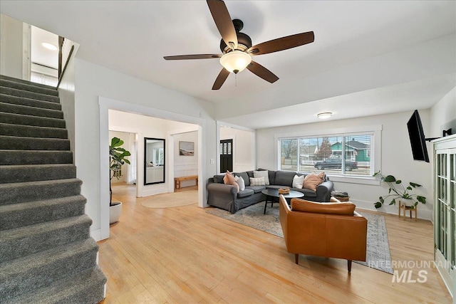 609 10th Ave S, Nampa, ID 83651 - living area featuring baseboards, light wood-style floors, stairs, and ceiling fan