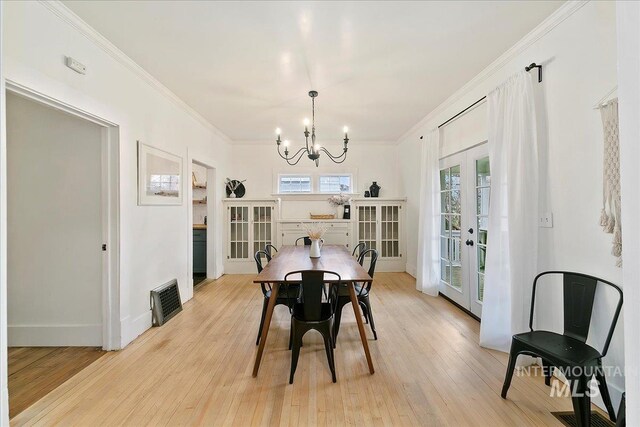 609 10th Ave S, Nampa, ID 83651 - dining space featuring a chandelier, light wood-style floors, and french doors