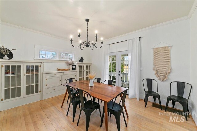 609 10th Ave S, Nampa, ID 83651 - dining area with crown molding, french doors, a chandelier, and light wood-style floors