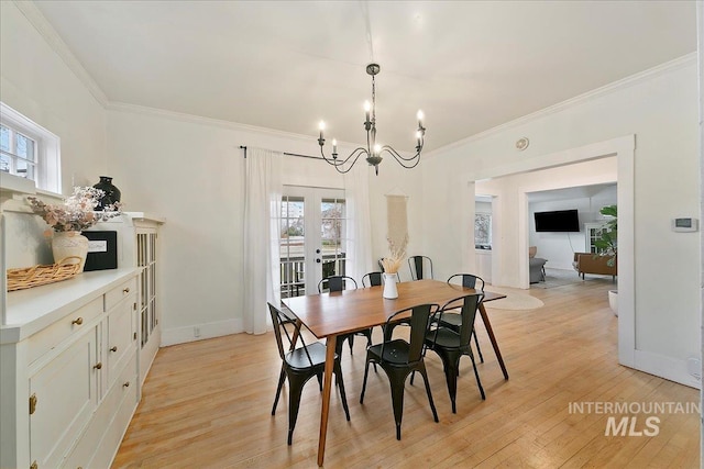 609 10th Ave S, Nampa, ID 83651 - dining area featuring a chandelier, a healthy amount of sunlight, ornamental molding, and french doors