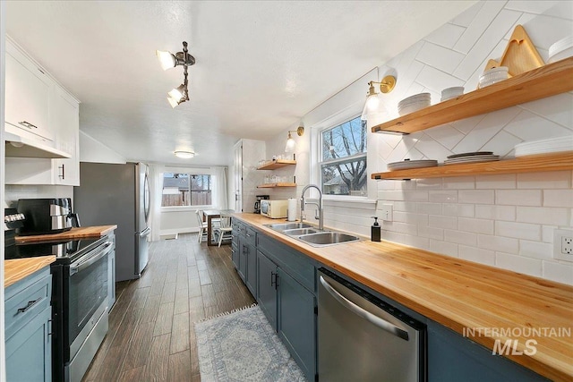 609 10th Ave S, Nampa, ID 83651 - kitchen featuring open shelves, a sink, butcher block countertops, and appliances with stainless steel finishes