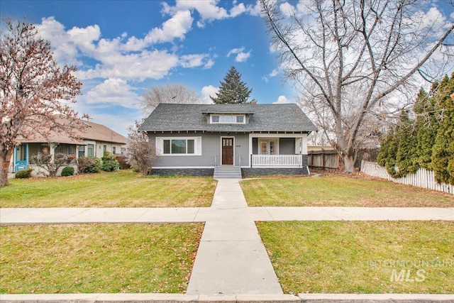 609 10th Ave S, Nampa, ID 83651 - bungalow-style home with a front lawn, fence, a porch, and a shingled roof