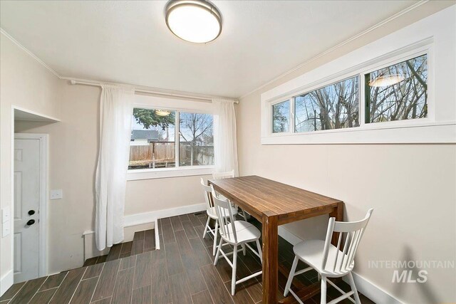 609 10th Ave S, Nampa, ID 83651 - dining area featuring crown molding, baseboards, and dark wood-style flooring
