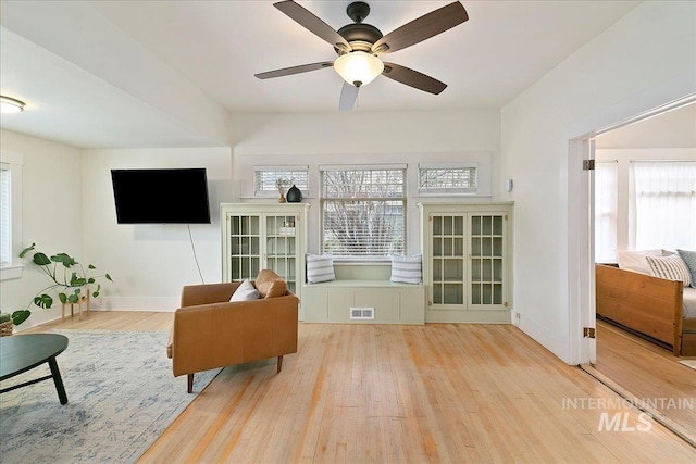 609 10th Ave S, Nampa, ID 83651 - living area with wood-type flooring, a wealth of natural light, visible vents, and baseboards