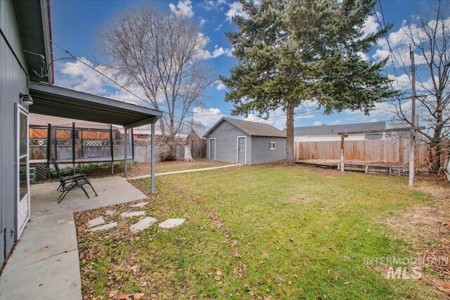 609 10th Ave S, Nampa, ID 83651 - view of yard featuring a fenced backyard, an outdoor structure, and a patio