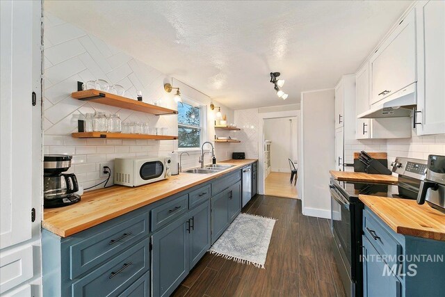 609 10th Ave S, Nampa, ID 83651 - kitchen featuring a sink, white microwave, butcher block countertops, electric range oven, and under cabinet range hood