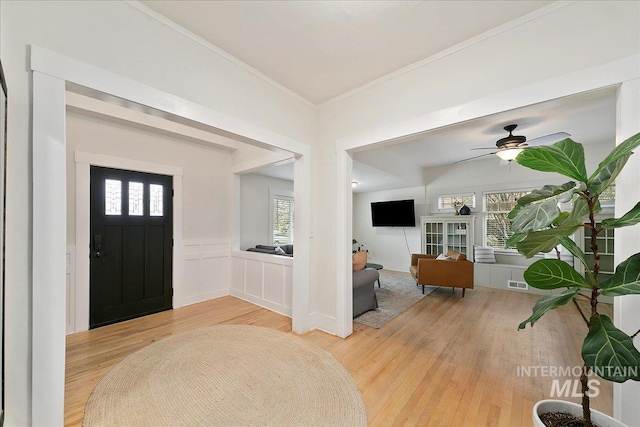 609 10th Ave S, Nampa, ID 83651 - foyer entrance with ornamental molding, light wood-style flooring, visible vents, and plenty of natural light