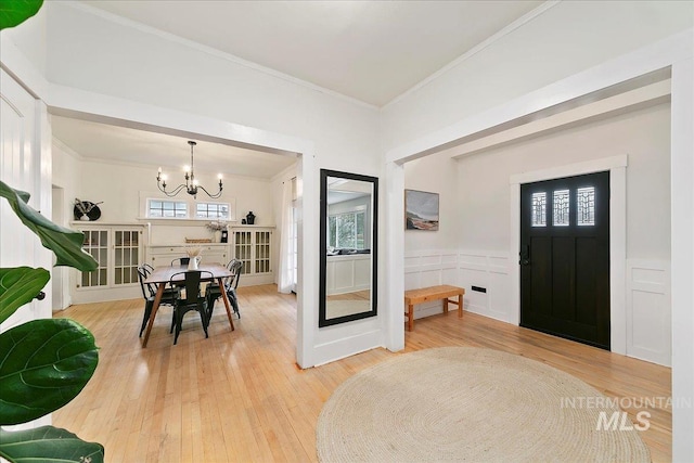 609 10th Ave S, Nampa, ID 83651 - foyer entrance with hardwood / wood-style floors, wainscoting, ornamental molding, and an inviting chandelier