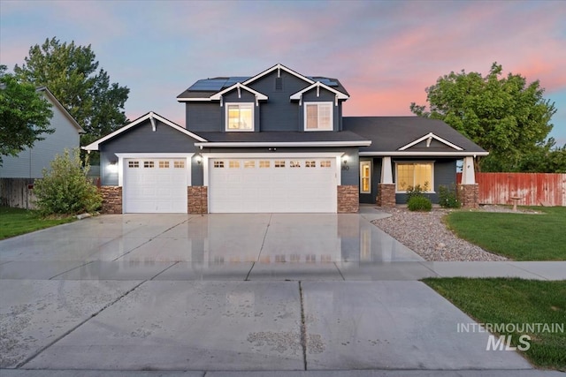 80 Cobblestone Ct, Middleton, ID 83644 - craftsman inspired home featuring stone siding, roof mounted solar panels, driveway, an attached garage, and covered porch