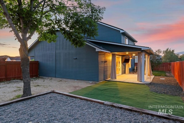 80 Cobblestone Ct, Middleton, ID 83644 - back of house at dusk featuring a patio area and a fenced backyard
