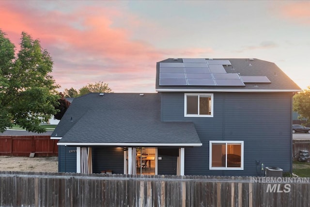 80 Cobblestone Ct, Middleton, ID 83644 - rear view of property featuring solar panels, a fenced front yard, and a porch