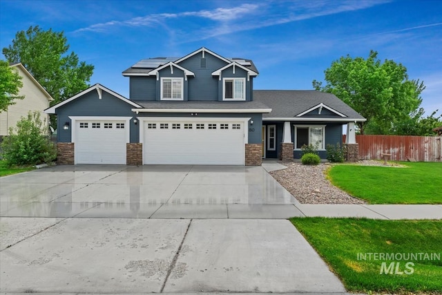 80 Cobblestone Ct, Middleton, ID 83644 - craftsman inspired home featuring stone siding, roof mounted solar panels, concrete driveway, and covered porch