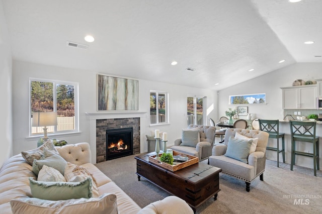 carpeted living room featuring a textured ceiling and vaulted ceiling