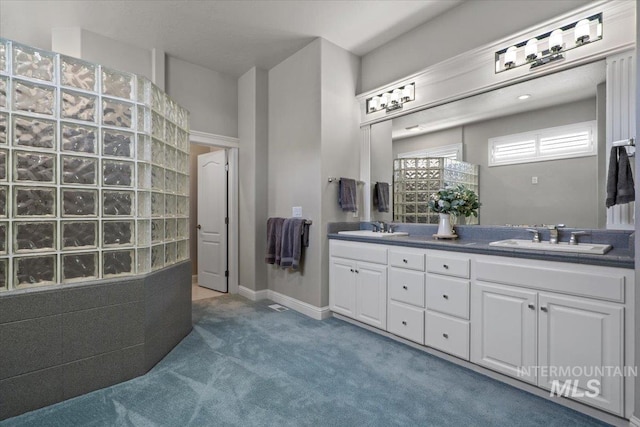 full bath with double vanity and walk in shower
