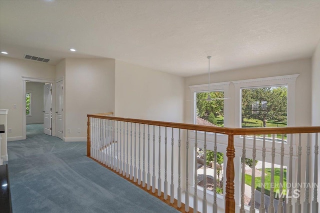 corridor featuring carpet floors, baseboards, and recessed lighting