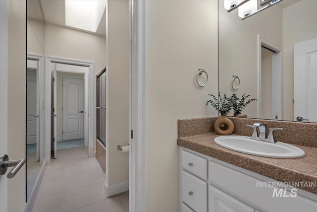bathroom with tile patterned floors and vanity