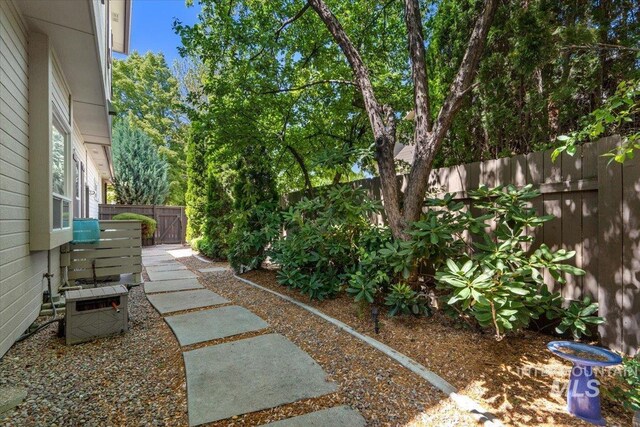 fenced backyard featuring cooling unit