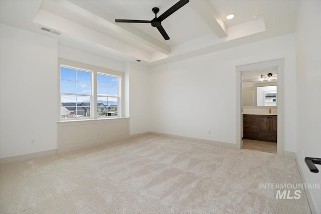 interior space with beam ceiling, ceiling fan, and a tray ceiling