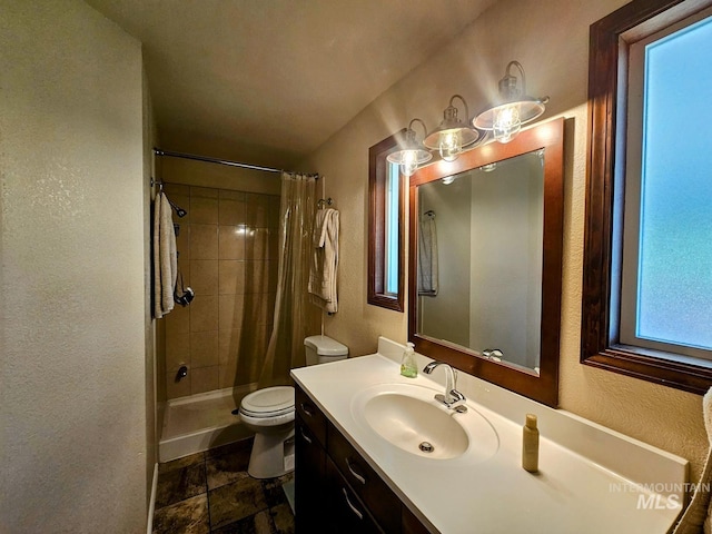 full bathroom with toilet, curtained shower, a textured wall, and vanity