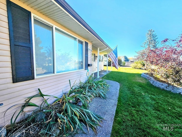 view of side of home featuring a yard