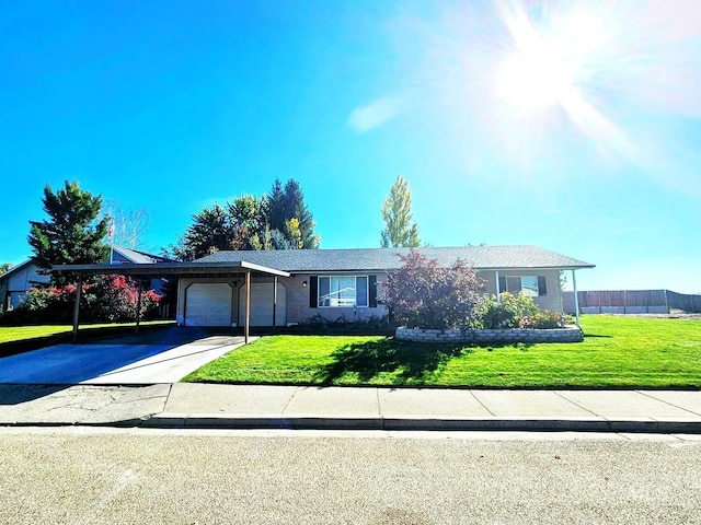 ranch-style home featuring driveway, a garage, and a front lawn