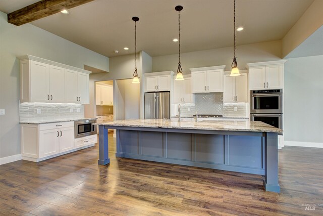 kitchen with white cabinets, backsplash, appliances with stainless steel finishes, and dark hardwood / wood-style floors