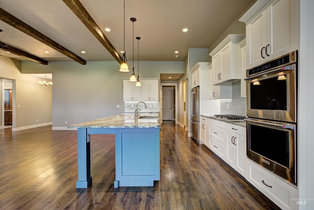 kitchen with backsplash, stainless steel appliances, dark hardwood / wood-style floors, and beam ceiling