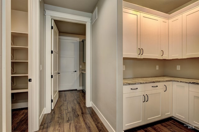 hallway featuring dark wood-type flooring