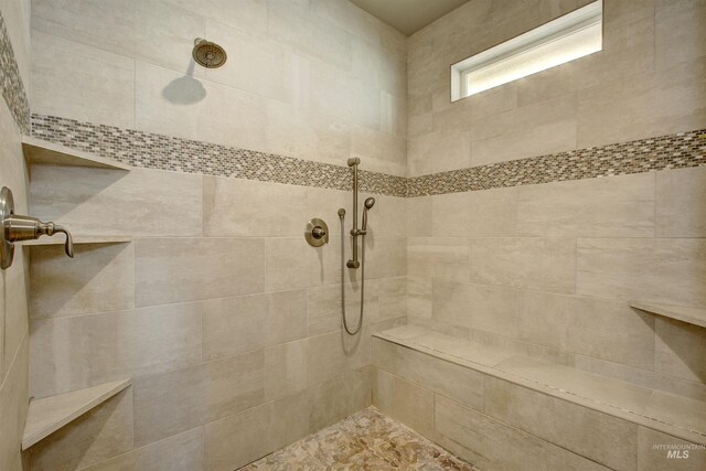 bathroom featuring tiled shower