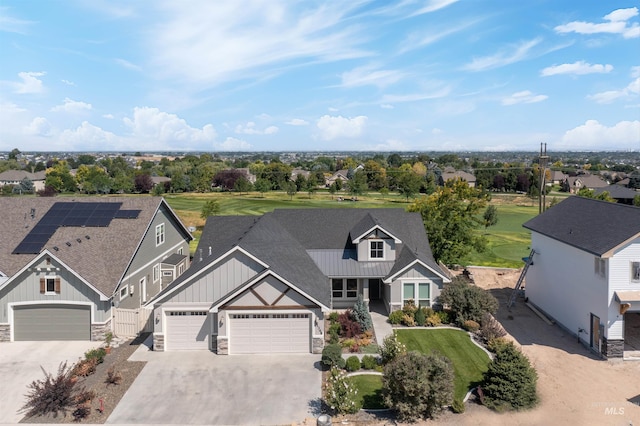 view of front of property featuring solar panels and a garage