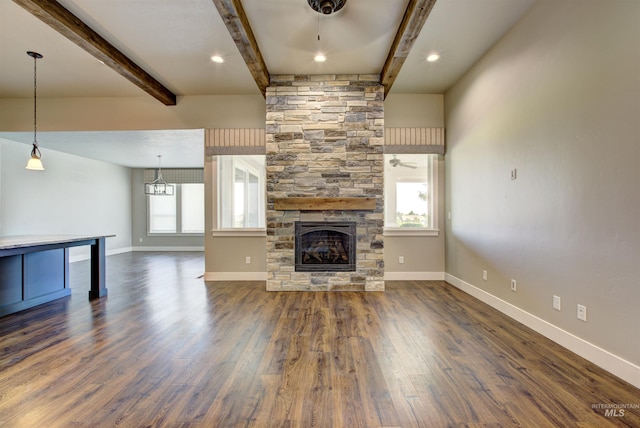 unfurnished living room with beamed ceiling, dark hardwood / wood-style floors, ceiling fan, and a fireplace