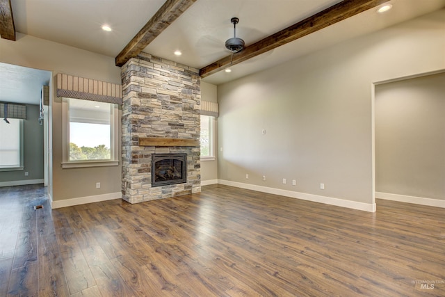 unfurnished living room with beamed ceiling, hardwood / wood-style flooring, ceiling fan, and a fireplace